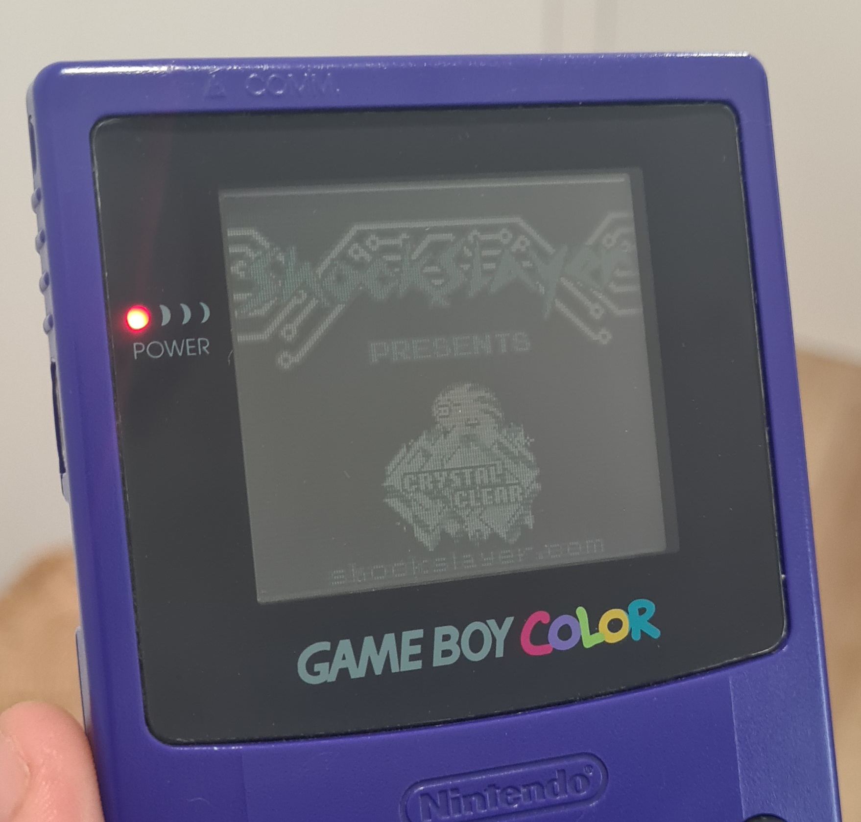 Pokemon Crystal Clear boot screen on a real purple Game Boy Color